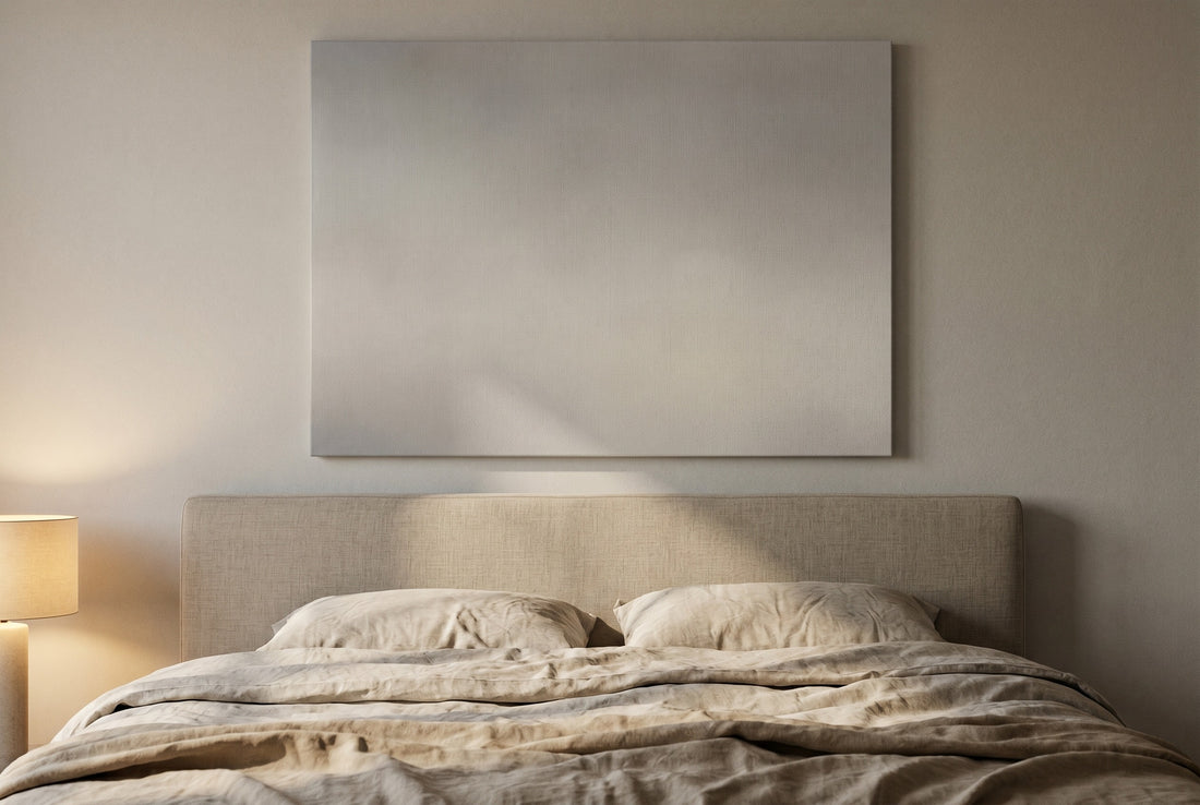 One soft muted abstract canvas centred above a linen-dressed bed